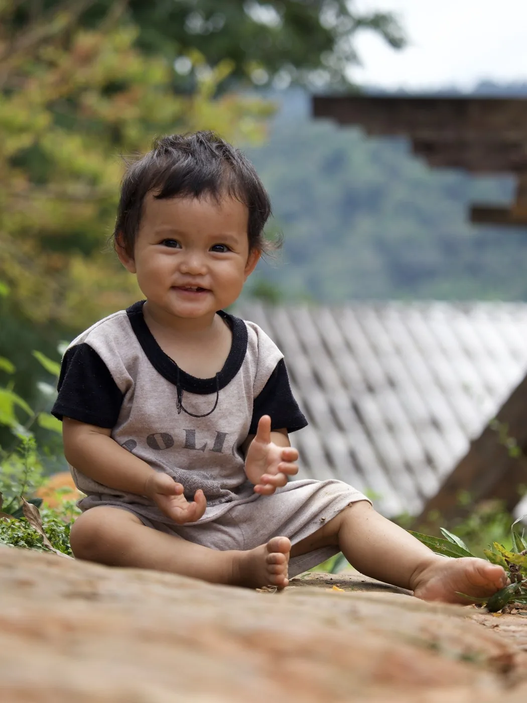 A smiling village toddler in warm daylight