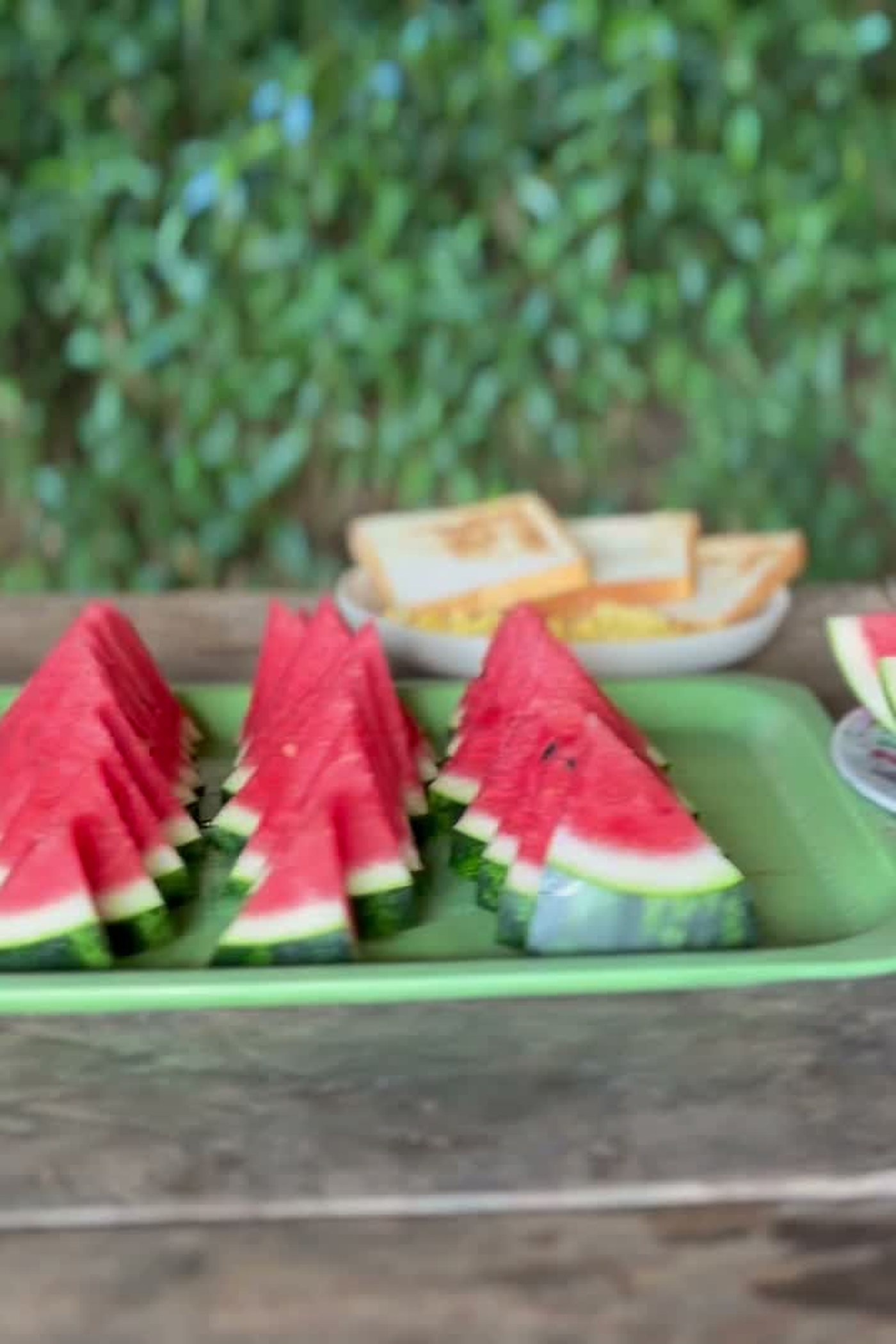 Toast, scrambled eggs and fresh watermelon on a wooden village table