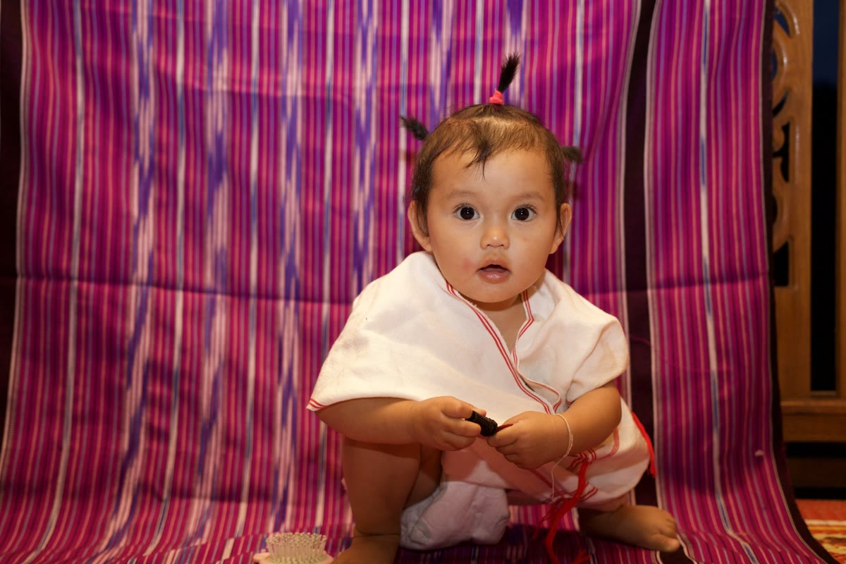A baby wearing traditional Karen dress